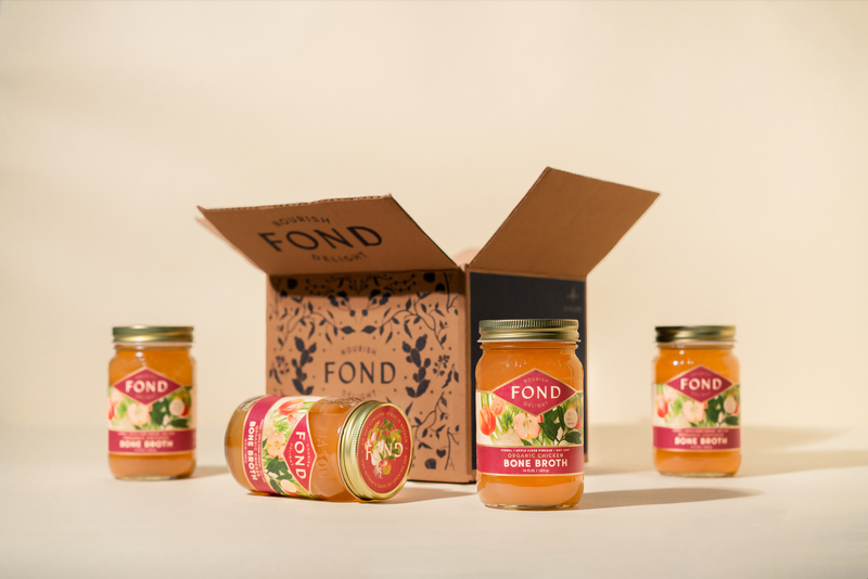 4 Jars of Mother's bone broth in front of the new 4 pack box